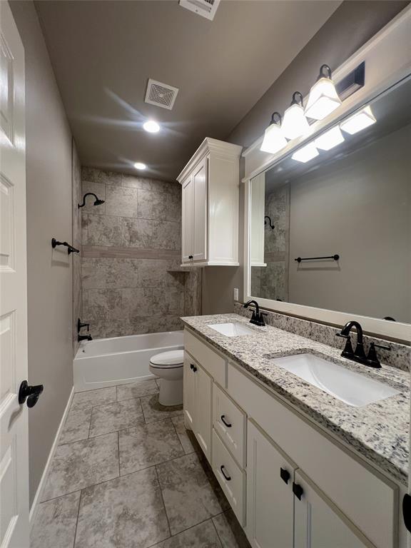 4309 NW 152nd Pl, Edmond, OK 73013 - full bathroom with toilet, shower / washtub combination, a sink, visible vents, and double vanity