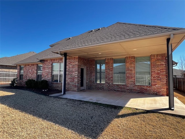 4309 NW 152nd Pl, Edmond, OK 73013 - back of property featuring a patio, brick siding, and fence