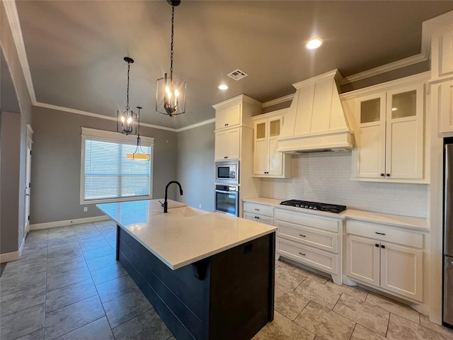 4309 NW 152nd Pl, Edmond, OK 73013 - kitchen featuring a kitchen island with sink, stainless steel appliances, a sink, custom range hood, and backsplash