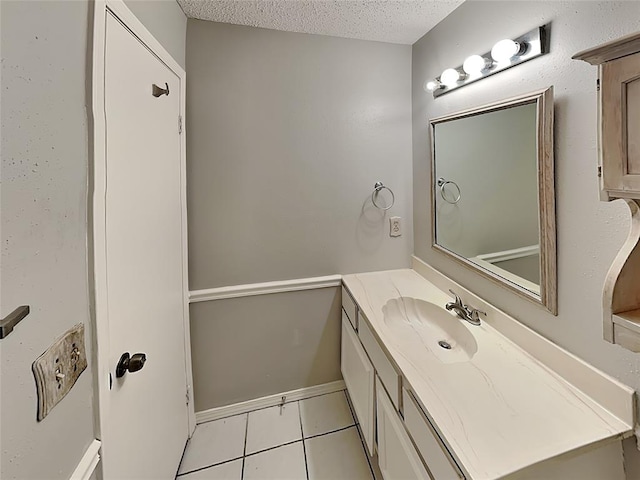 bathroom with vanity, a textured ceiling, and tile patterned flooring