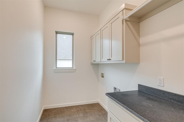 clothes washing area featuring cabinets, hookup for a washing machine, and electric dryer hookup