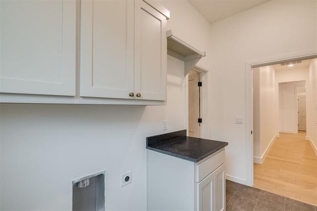 laundry area with cabinets, tile patterned floors, and electric dryer hookup