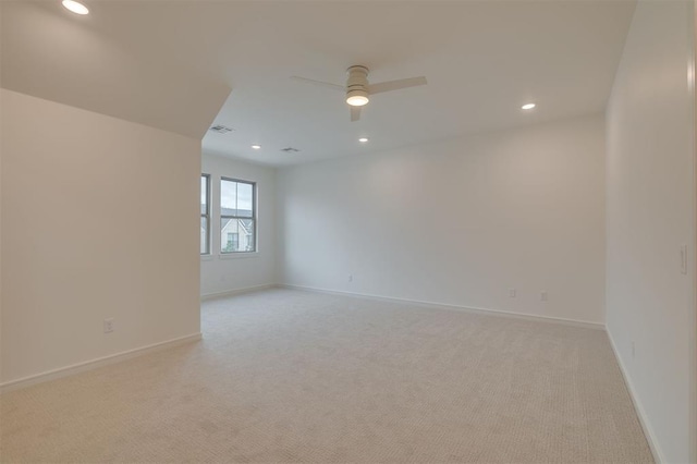 empty room featuring light carpet and ceiling fan