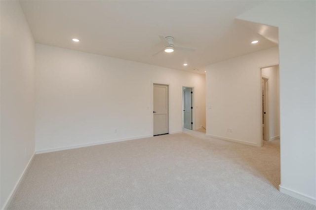 empty room with ceiling fan and light colored carpet