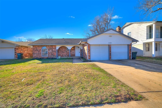 view of front of home with a garage and a front lawn