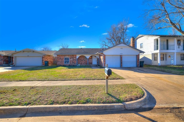 view of front of house with a front yard and a garage