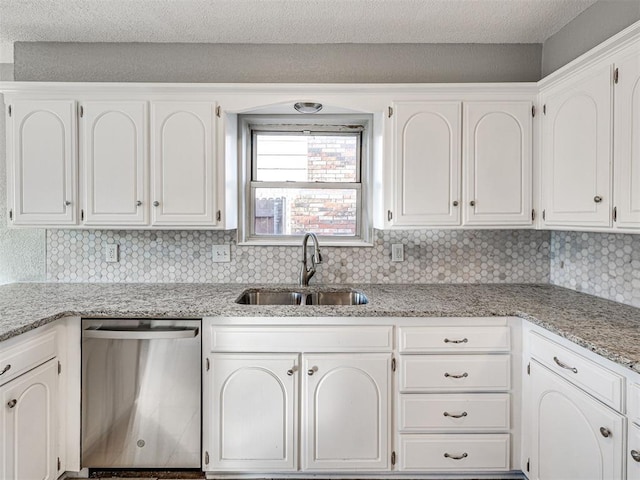 kitchen with decorative backsplash, dishwasher, white cabinets, and sink