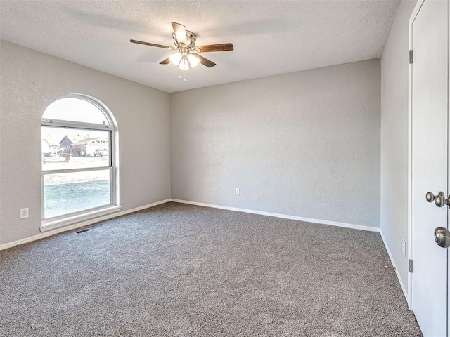 empty room featuring carpet flooring, a textured ceiling, and ceiling fan