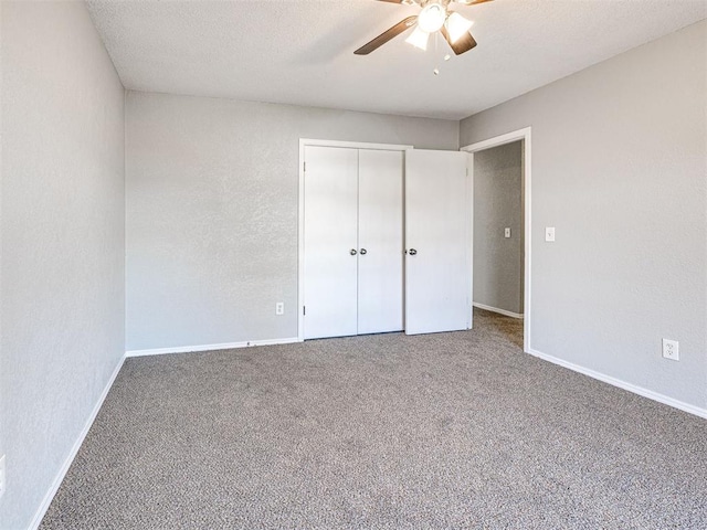 unfurnished bedroom with carpet, a textured ceiling, a closet, and ceiling fan