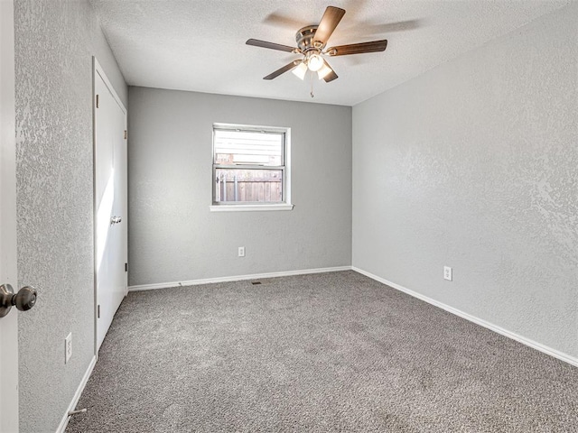 unfurnished room featuring carpet, ceiling fan, and a textured ceiling