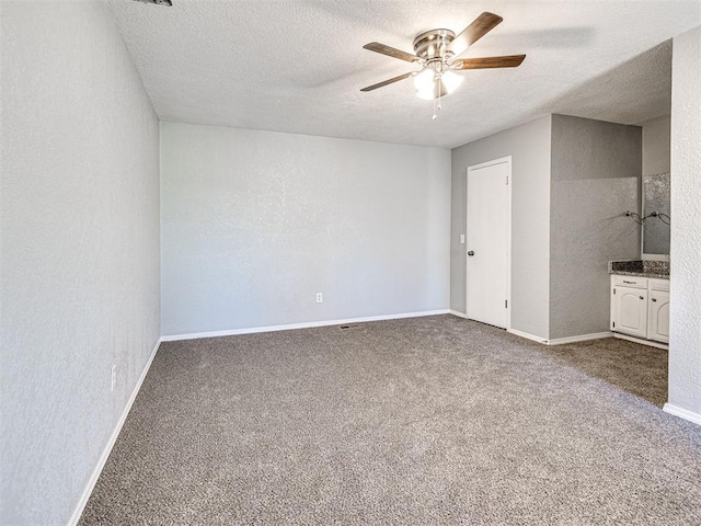 unfurnished bedroom with carpet flooring, ceiling fan, and a textured ceiling