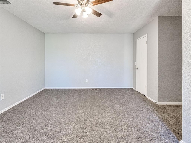 spare room featuring carpet flooring, ceiling fan, and a textured ceiling