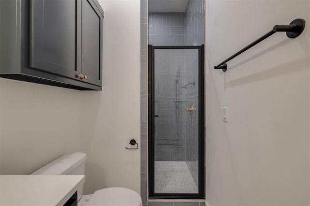 bathroom with vanity, toilet, and a shower with shower door