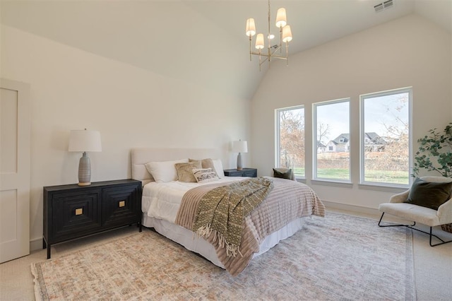 bedroom with light colored carpet, lofted ceiling, and an inviting chandelier