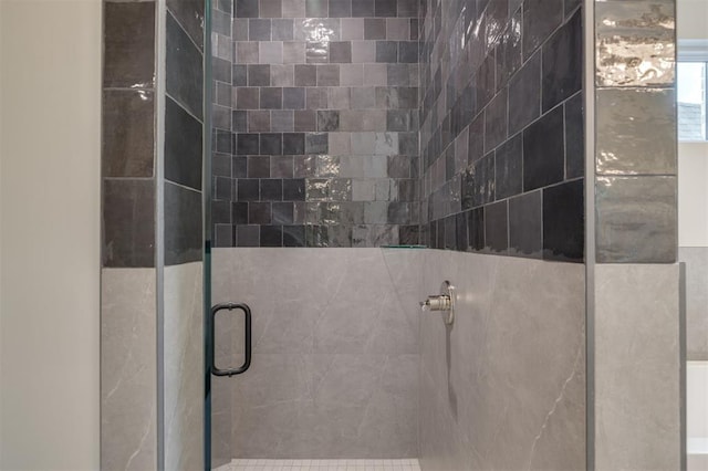 bathroom featuring a shower with door