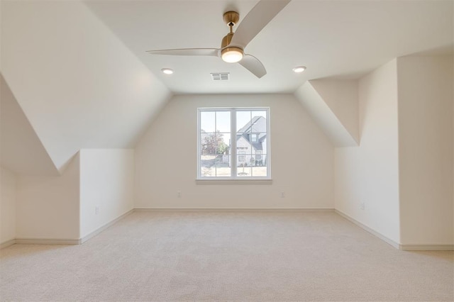 additional living space featuring light carpet, vaulted ceiling, and ceiling fan