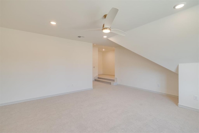 additional living space featuring ceiling fan, light colored carpet, and lofted ceiling