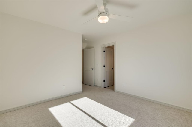 empty room with light colored carpet and ceiling fan