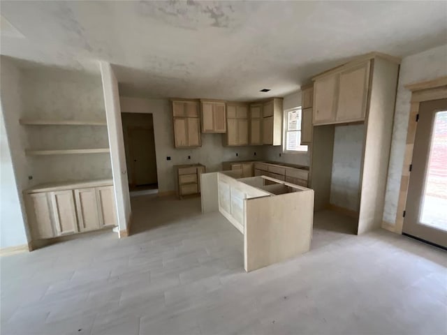 kitchen with plenty of natural light, a center island, and light brown cabinets