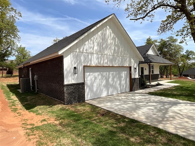 2402 Black Jack Way, Blanchard, OK 73010 - view of property exterior with roof with shingles, central AC, brick siding, a garage, and concrete driveway