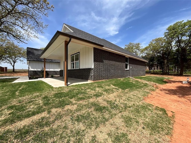 2402 Black Jack Way, Blanchard, OK 73010 - view of side of home featuring a lawn, a patio, a shingled roof, and brick siding
