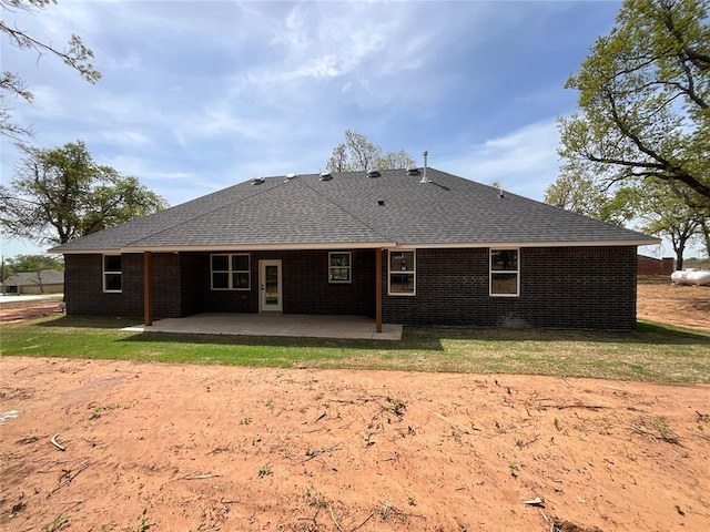 2402 Black Jack Way, Blanchard, OK 73010 - back of house with brick siding, a patio area, and roof with shingles