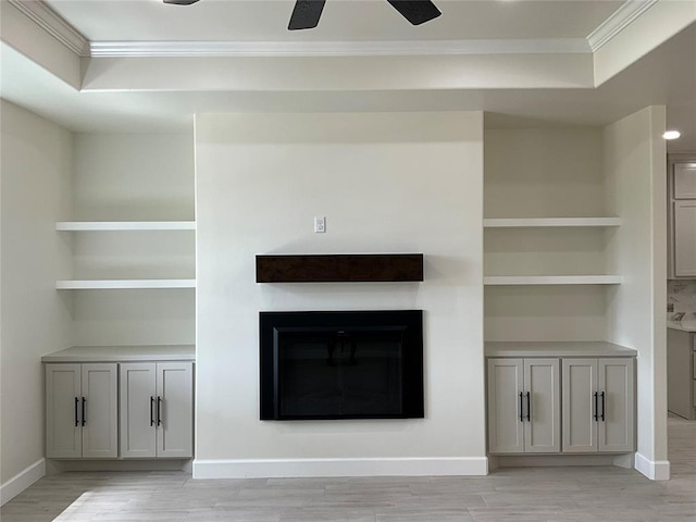 2402 Black Jack Way, Blanchard, OK 73010 - unfurnished living room featuring a ceiling fan, baseboards, a glass covered fireplace, light wood-style floors, and ornamental molding