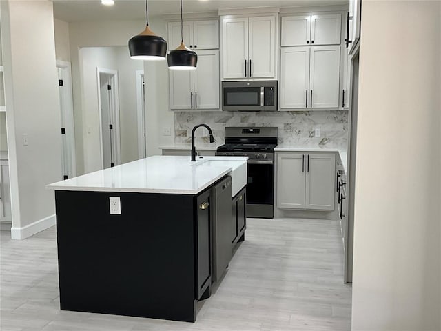 2402 Black Jack Way, Blanchard, OK 73010 - kitchen with light countertops, appliances with stainless steel finishes, backsplash, and light wood finished floors