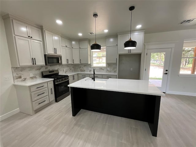 2402 Black Jack Way, Blanchard, OK 73010 - kitchen with baseboards, a sink, light countertops, and stainless steel appliances