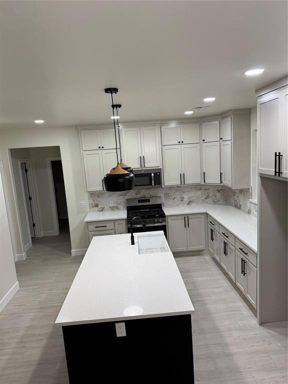 2402 Black Jack Way, Blanchard, OK 73010 - kitchen with appliances with stainless steel finishes, tasteful backsplash, a sink, baseboards, and light countertops