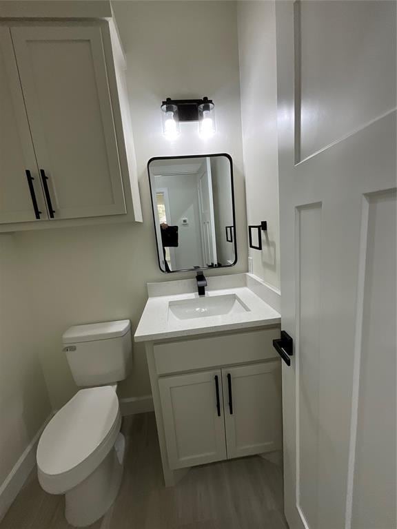 2402 Black Jack Way, Blanchard, OK 73010 - bathroom featuring toilet, baseboards, and wood finished floors