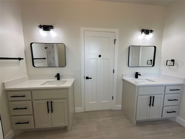 2402 Black Jack Way, Blanchard, OK 73010 - full bath featuring baseboards, two vanities, and a sink