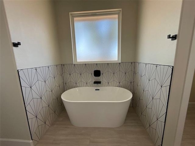 2402 Black Jack Way, Blanchard, OK 73010 - full bath with a wainscoted wall, a soaking tub, and tile walls