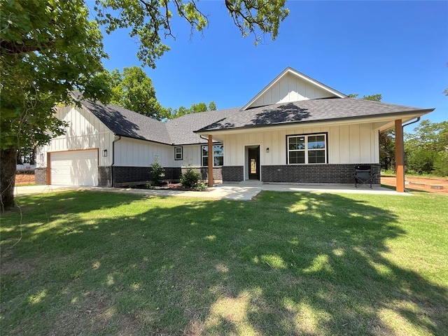 2402 Black Jack Way, Blanchard, OK 73010 - view of front of home featuring board and batten siding, roof with shingles, a front yard, brick siding, and an attached garage