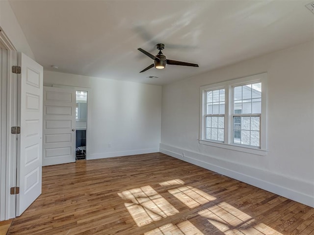 empty room with wood-type flooring and ceiling fan