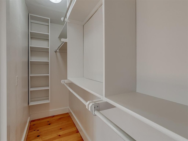 spacious closet with hardwood / wood-style flooring