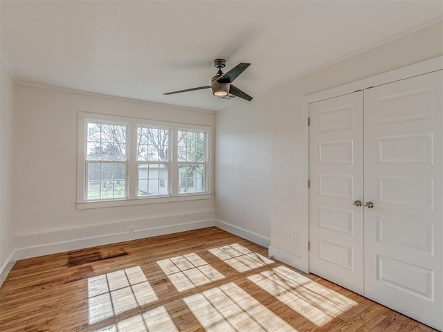 spare room featuring ceiling fan, crown molding, and light hardwood / wood-style flooring