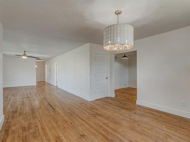 empty room with light hardwood / wood-style flooring and ceiling fan