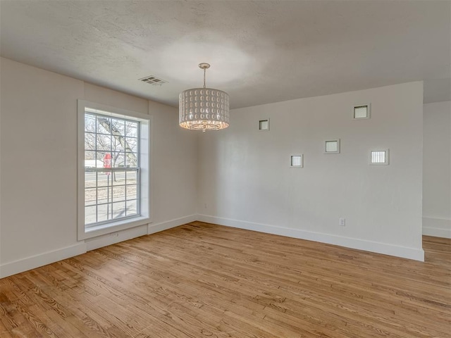 2832 NW 45th St, Oklahoma City, OK 73112 - empty room with a chandelier and light wood-style floors