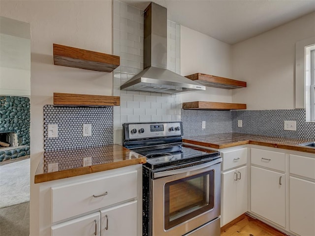 2832 NW 45th St, Oklahoma City, OK 73112 - kitchen featuring open shelves, stainless steel range with electric cooktop, wall chimney exhaust hood, white cabinetry, and tasteful backsplash