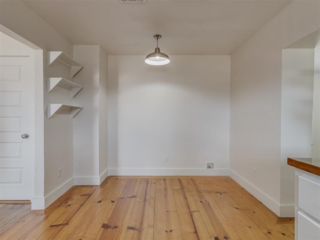 unfurnished dining area with light wood-type flooring