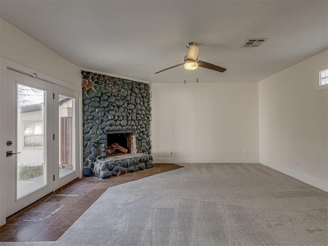 living room with ceiling fan, a fireplace, and carpet