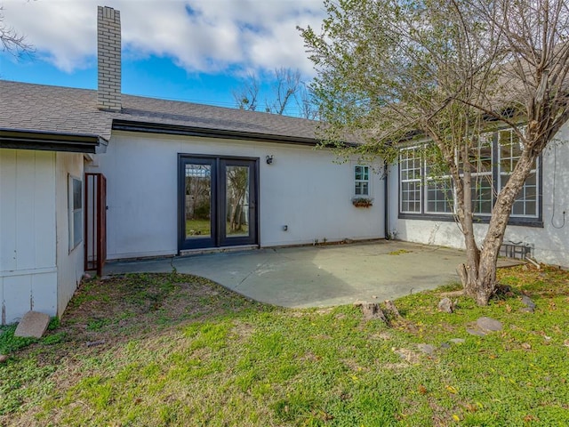 rear view of property featuring a patio area