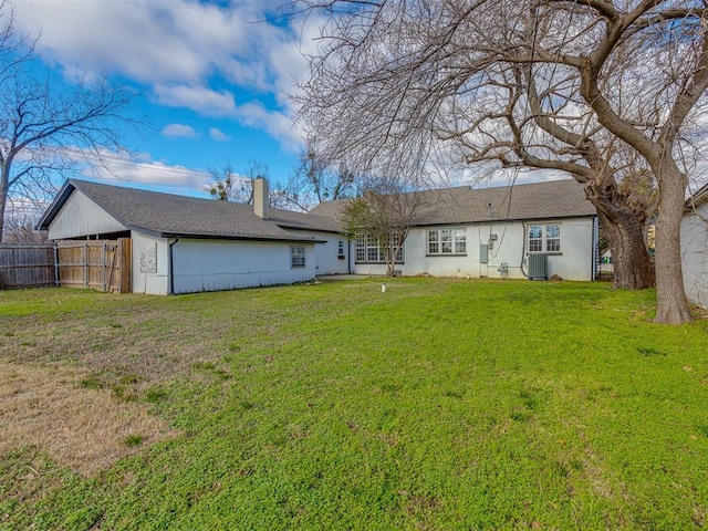 back of house with a lawn