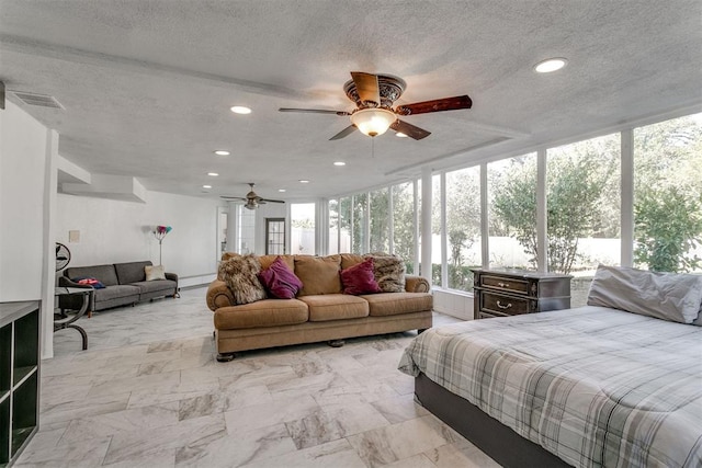 bedroom featuring ceiling fan, a wall of windows, and a textured ceiling