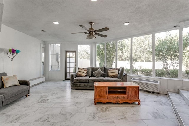 sunroom with an AC wall unit and ceiling fan