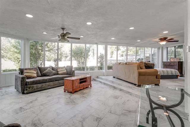 sunroom with a wealth of natural light and ceiling fan