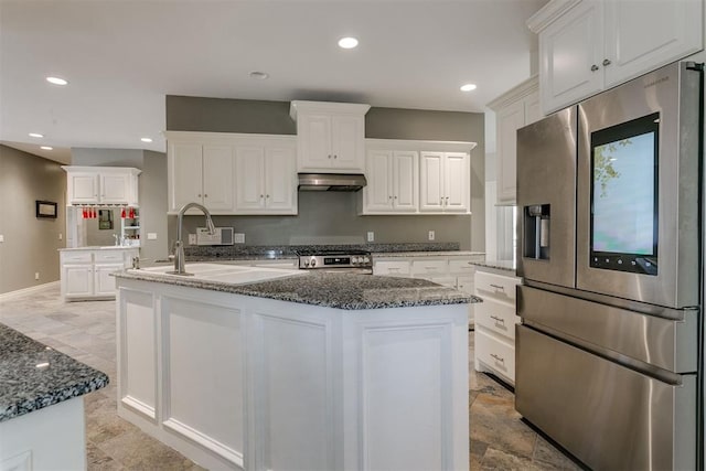 kitchen with a center island with sink, white cabinets, and appliances with stainless steel finishes