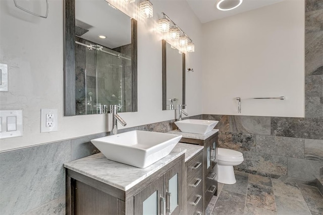 bathroom featuring vanity, an enclosed shower, and toilet