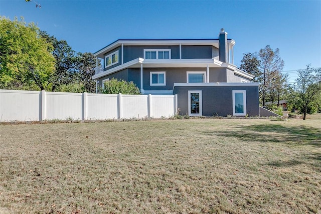 5100 Burr Oaks Rd, Oklahoma City, OK 73105 - rear view of house featuring stucco siding, fence, and a lawn